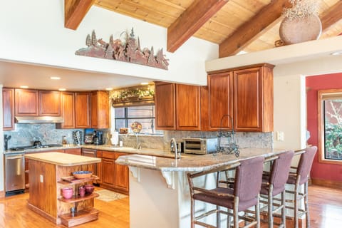 Fully-equipped kitchen with an island and barstool seating.