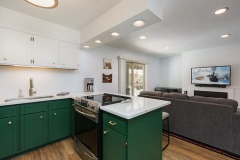 Updated, Fully Stocked Kitchen with Breakfast Bar and Seating - View of the Living Room and TV