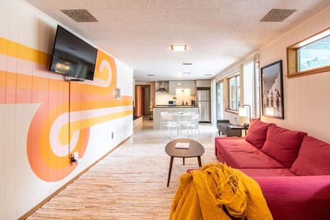 Large living space with a pullout couch that is the size of a queen bed.