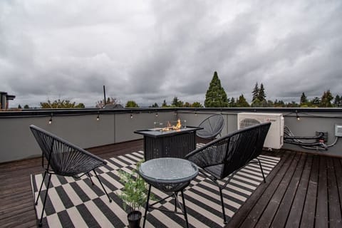 Relaxing rooftop, comfortably seats six people with the outdoor furniture (two chairs have been added since the photo) - enjoy the fire pit on a cool day or in the evening!