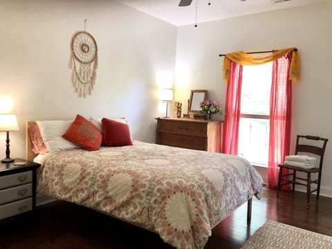 Master bedroom with queen bed, antique pine dresser and en-suite full bathroom