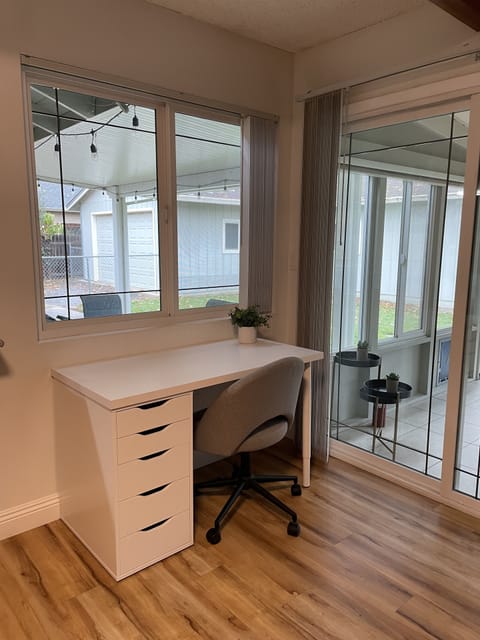 Desk/Work area overlooking back patio/yard/sun room...