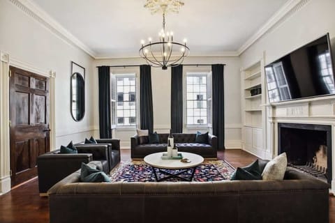 Welcome! Living Room | Grand Open Concept Living Room with Fireplace and TV | First Floor