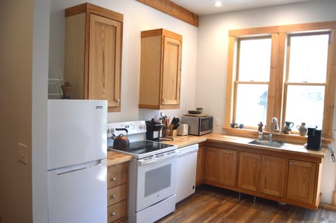 Back suite kitchen fully provisioned with fridge, stove, dishwasher, microwave