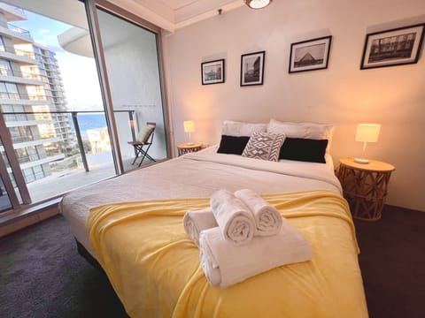 Master bedroom with Ocean View, TV, featuring a sumptuous queen-sized bed