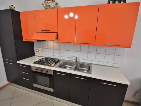 Cabinetry, Countertop, Tap, Kitchen Appliance, Kitchen, Kitchen Stove, Sink, Orange, Building, Tableware