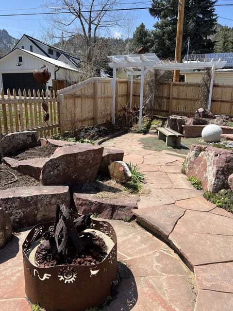 fire pit, fountain, and hammock in the backyard
