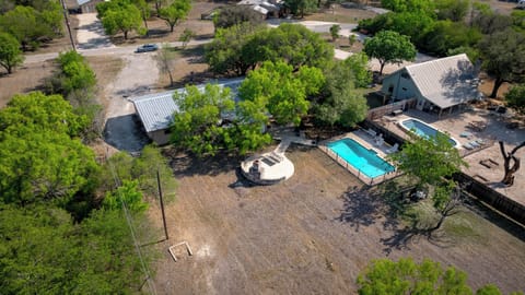 Aerial view of house + swimming pool