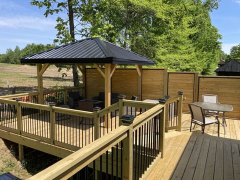 Relax around the fireplace on this brand new deck in the backyard!