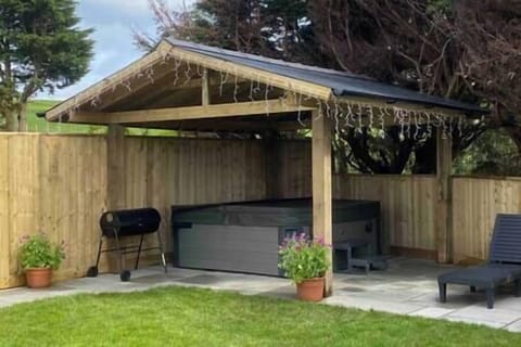 Hot tub under cover charcoal BBQ