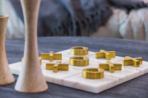 Play a round of tic-tac-toe on this luxe marble and brass coffee table set