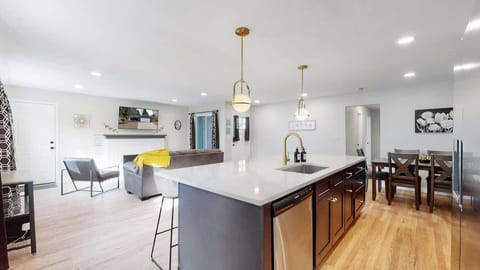 A beautifully designed kitchen with sleek dark cabinetry, stainless steel appliances, and a spacious island, offering both functionality and style.