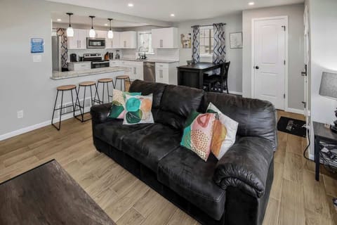 The spacious living area features a comfortable, stylish sofa, perfect for relaxing after a day of exploring.