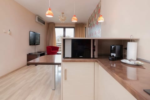 A close-up of the kitchen counter, showing a coffee machine, kettle, and other essentials.