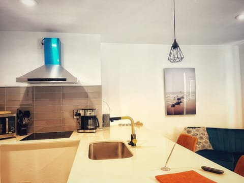Fully-equipped kitchen with pots, pans and utensils.