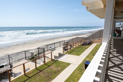 Oceanfront view of sandy beach and waves from upper-level balcon