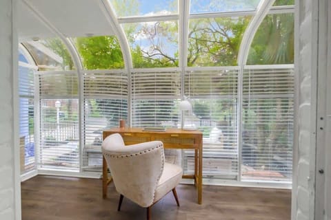 Very comfortable desk and chair in bright sunroom space, over looking the yard.