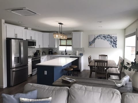 Kitchen and dining area with island. Table seats 8-9 comfortably with bench. 