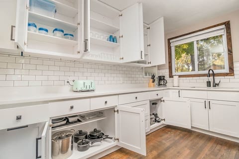 Cook meals in the newly updated kitchen. Kitchen includes nearly any basic cookware you would need: pots & pans, utensils, plates/bowls/cups, hand mixer, blender, mixing bowls, can opener, knives & cutting board, baking tins, glass casserole dishes.