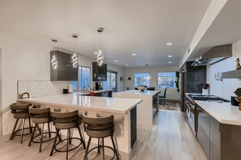 Luxury kitchen with bar seating for four and dining table seating for six