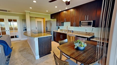 Open kitchen space with modern, updated appliances and elegant granite countertops.