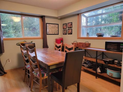 dining area for 6, and shelves filled with kitchen appliances.