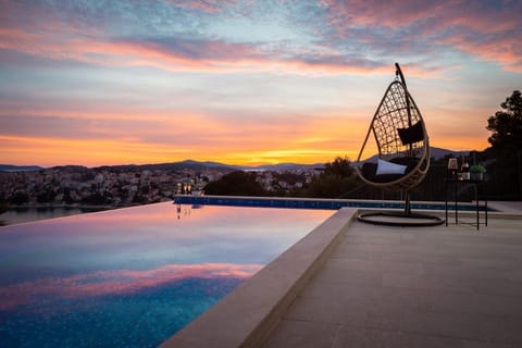 An infinity pool, sun loungers