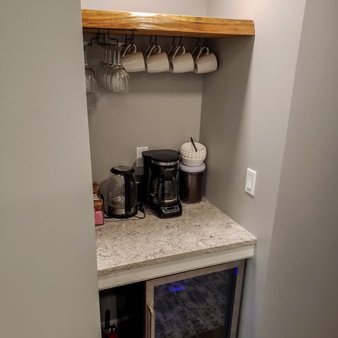12-cup drip coffee maker, coffee grinder, electric kettle, & beverage fridge.