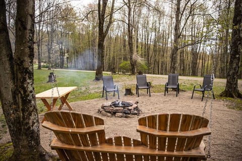 Outdoor fire pit and sitting area next to the garage