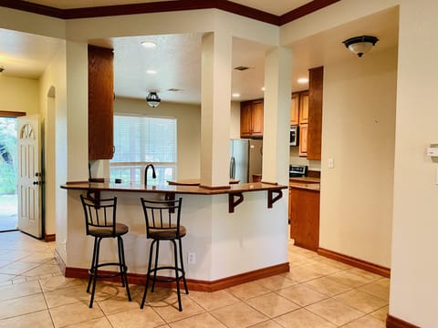 Kitchen bar open to livingroom