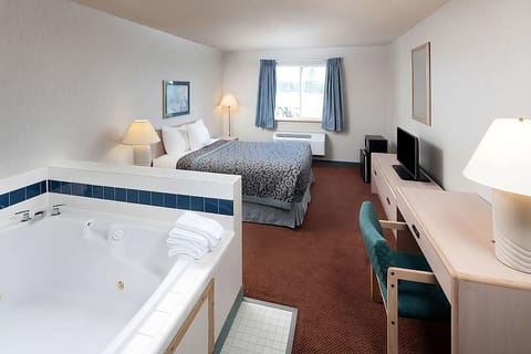 Unit a King size bed with flat screen TV and a jetted tub.