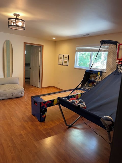 Upstairs game room with skee ball and basketball.