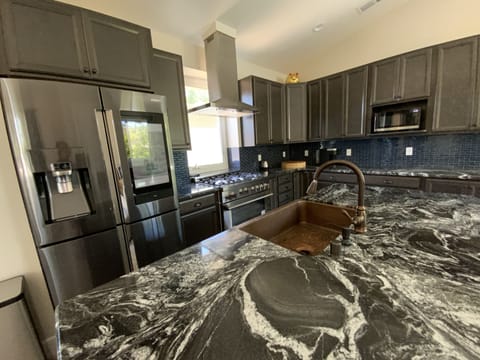 Huge Intergalactic-looking Granite countertops. Beautiful copper sink
