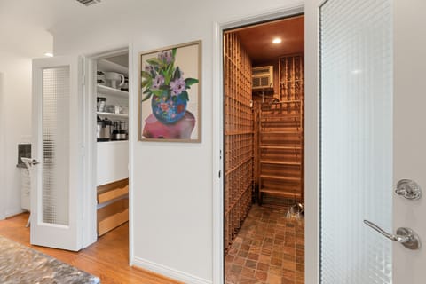 Temperature-controlled wine cellar with brick flooring and custom racking to store your finest vintages in style.