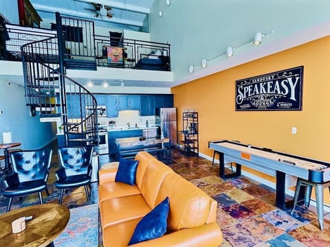 Loft-Style Entertainment Haven
This open-concept loft blends fun and function with a spacious layout, a vintage-inspired shuffleboard table, and a sleek kitchen. Perfect for entertaining or kicking back in style.