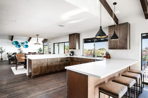 Discover culinary elegance, featuring a spacious open kitchen with modern finishes, natural light, and stunning views—ideal for gathering and entertaining