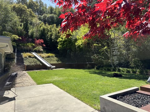 Private spacious back yard w/ fire pit, built in benches & second seating area