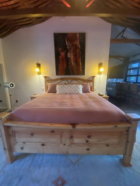 Mexican mansion bed.  Handmade linens. David Barnes artwork from Mendocino, CA.