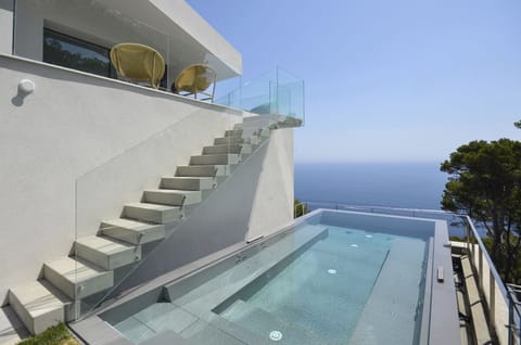 An infinity pool, sun loungers