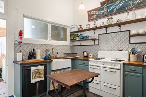 Kitchen sink and dishwasher with view to laundry room.