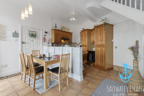Fully equipped kitchen and dining area with table to seat 4 guests.