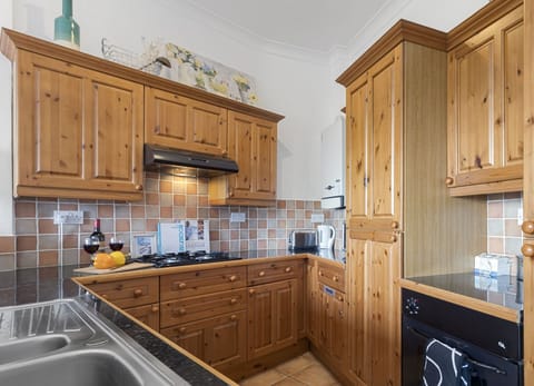 Fully equipped kitchen and dining area with table to seat 4 guests.
