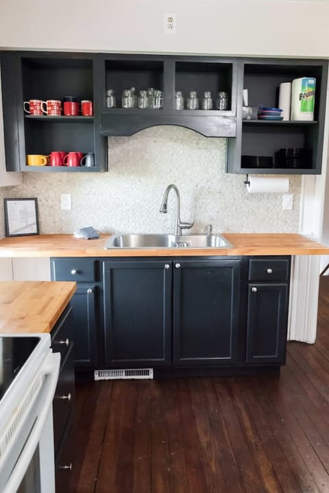 The kitchen sink has 2 bowls, one slightly smaller than the other