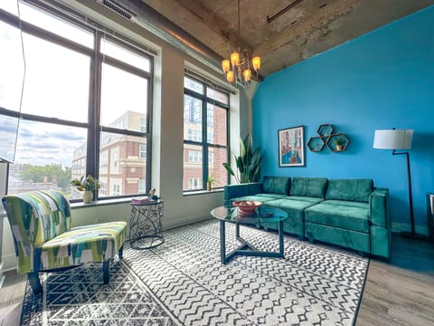 Spacious living room with a lot of natural light and large windows.