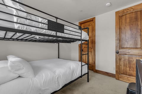 Who calls top bunk? Your kids will fall in love with this bedroom, which features a metal-framed bunk bed with queen-sized mattresses.