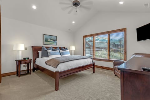 Enjoy lounging in the king-sized bed in this master suite, which boasts an ensuite bathroom, ample closet space, and a cozy reading nook.