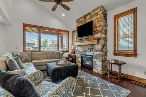 Enter the living room of your dreams, complete with a roaring stone fireplace, easily-accessible TV, and a full-sized pullout couch for guests to sleep on.