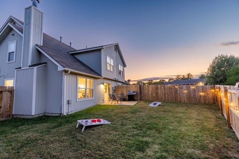 Enjoy a private, fenced backyard that will help you and your family unwind in daylight or at night thanks to our outdoor chairs, gas grill, cornhole, and string lights.  