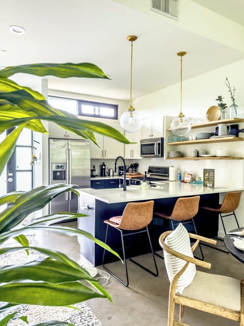 Modern elegance awaits with stainless steel appliances, stylish bar seating, and great natural light!