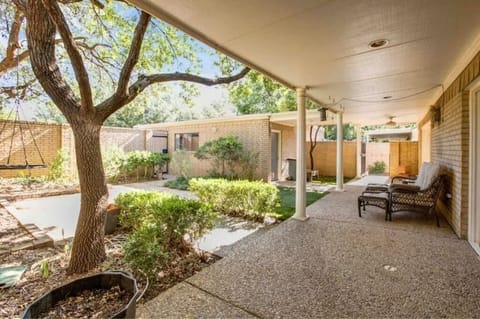 Back patio with tree house, trampoline and smoker